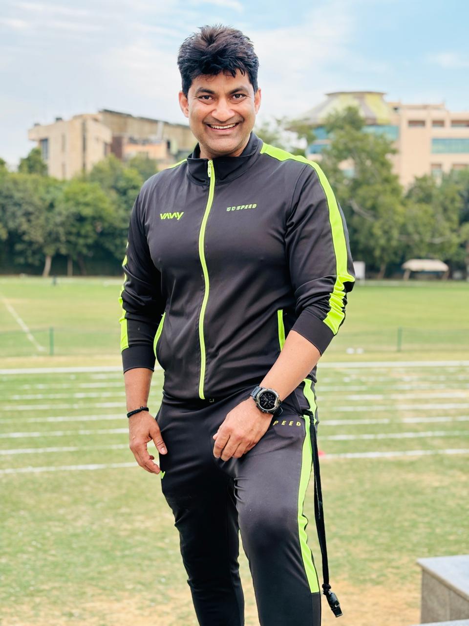 Amit Khanna, Fastest Man of India (1995-1998), in professional athletic gear on the track demonstrating coaching techniques